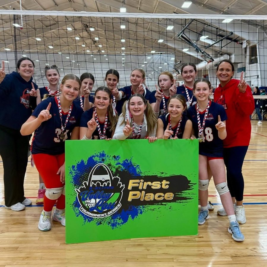 314 Volleyball Club players and coaches holding a First Place banner after winning the Ozark League championship